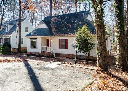 a view of a house with a yard covered in snow