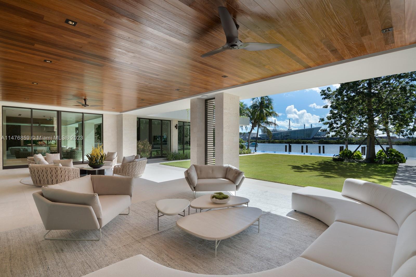 40 Palm Avenue Miami Beach, FL 33139 - Photo 16 of 62 a view of a patio with couches table and chairs under an umbrella
