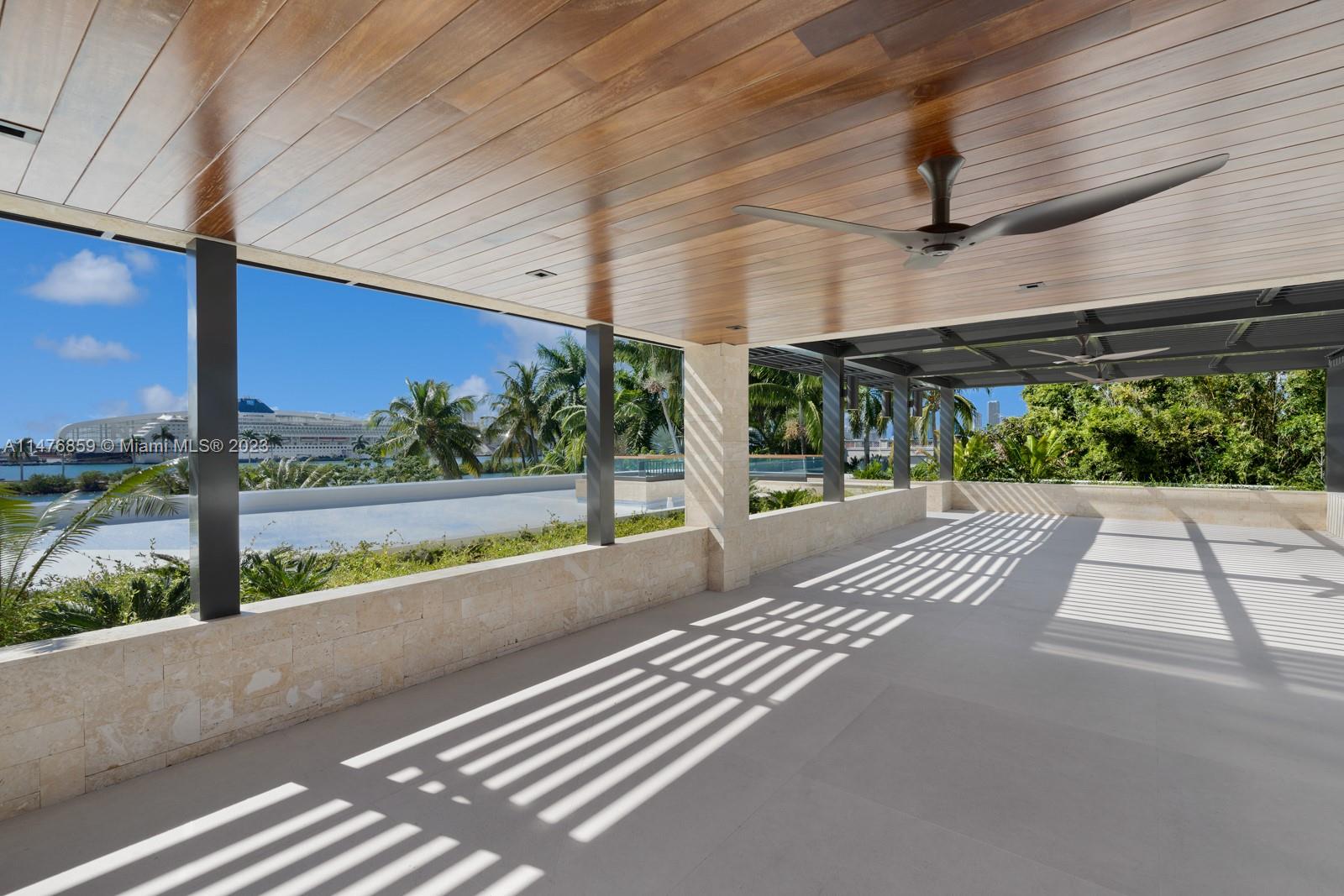 40 Palm Avenue Miami Beach, FL 33139 - Photo 19 of 62 a view of a patio with a table and chairs next to a road