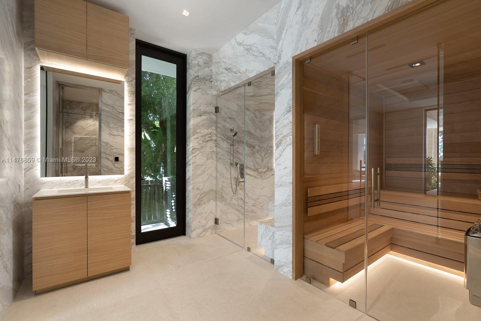 40 Palm Avenue Miami Beach, FL 33139 - Photo 21 of 62 a view of a bathroom with a glass door and a shower