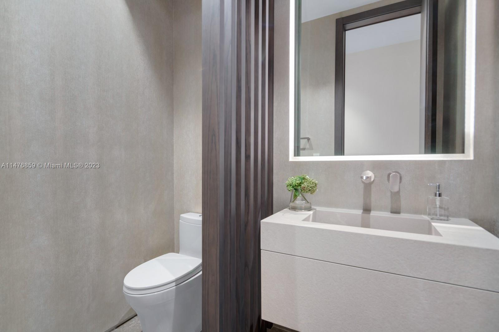 40 Palm Avenue Miami Beach, FL 33139 - Photo 22 of 62 a bathroom with a sink a toilet and mirror