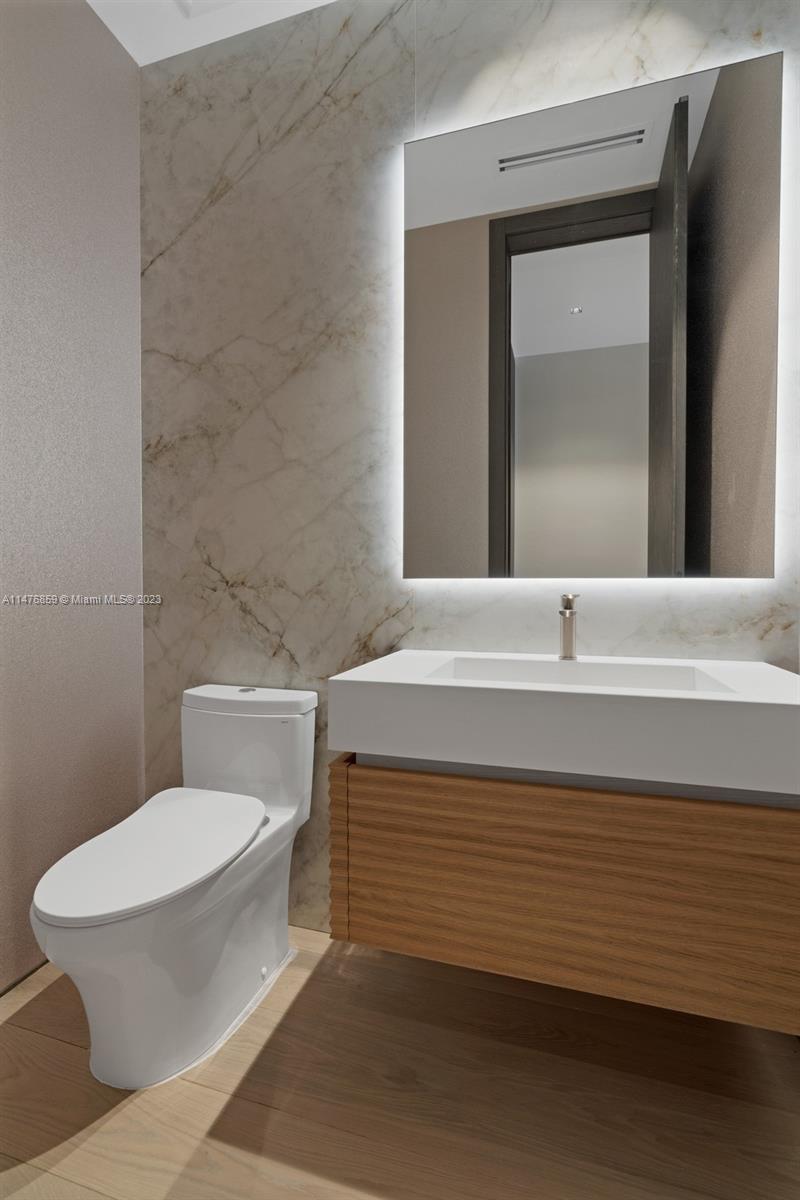 40 Palm Avenue Miami Beach, FL 33139 - Photo 28 of 62 a bathroom with a sink a toilet and mirror