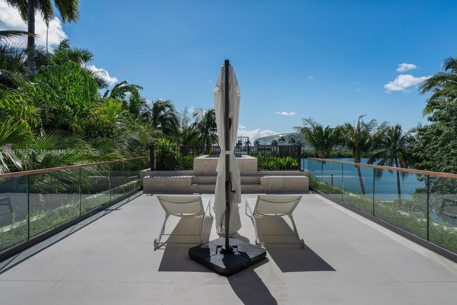 40 Palm Avenue Miami Beach, FL 33139 - Photo 31 of 62 a view of a patio with a table chairs and a floor to ceiling window