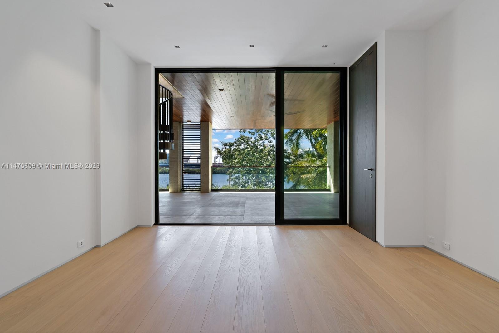 40 Palm Avenue Miami Beach, FL 33139 - Photo 36 of 62 a view of an empty room with wooden floor and a window