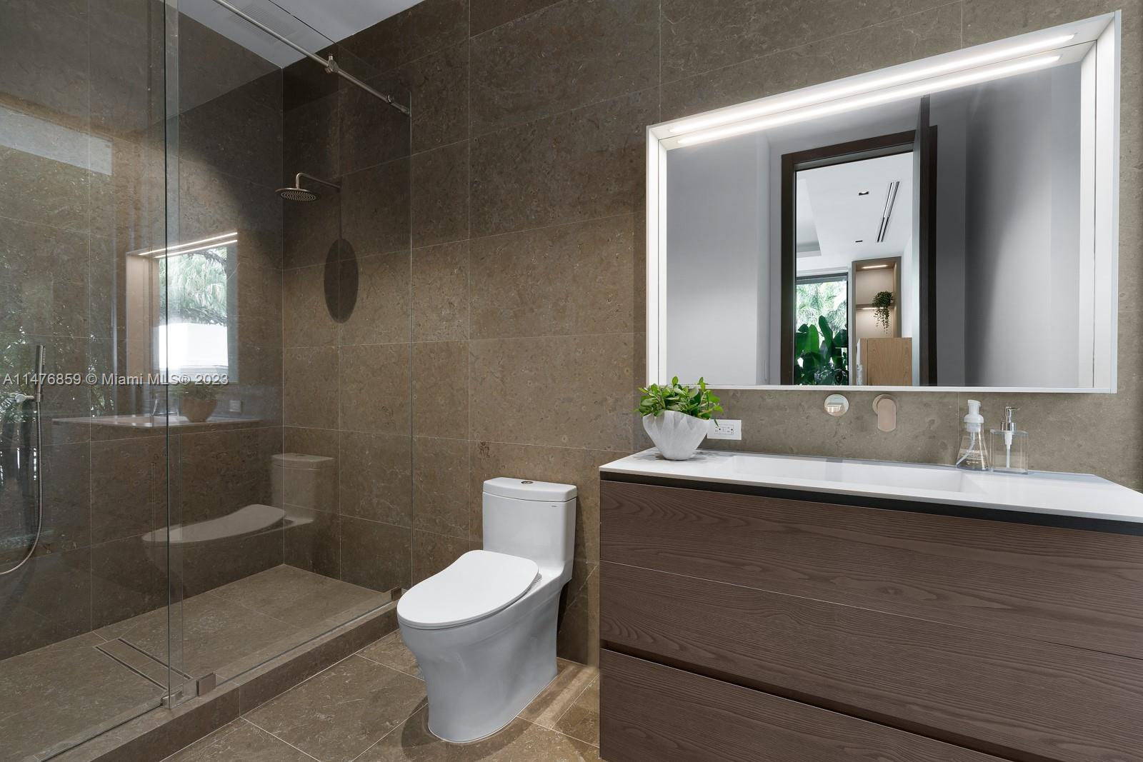 40 Palm Avenue Miami Beach, FL 33139 - Photo 41 of 62 a bathroom with a sink a toilet and mirror