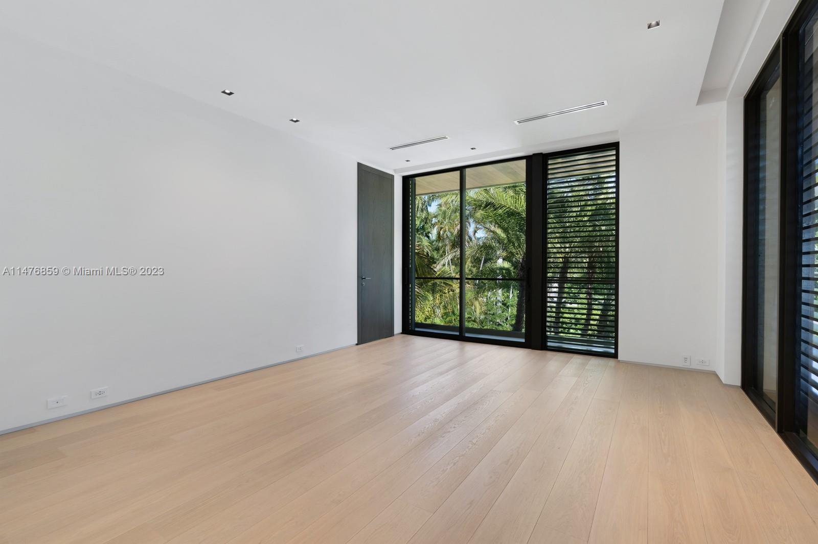 40 Palm Avenue Miami Beach, FL 33139 - Photo 43 of 62 a view of an empty room with wooden floor and a window