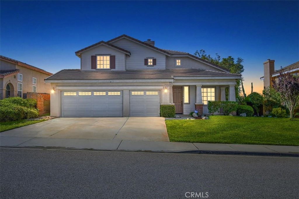 21423 Tyler Road Moreno Valley, CA 92557 - Photo 1 of 1 a front view of a house with a yard and garage