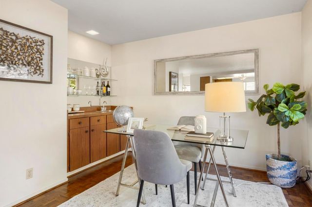a view of a dining room with furniture and a potted plant