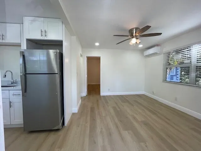 a view of a kitchen with a refrigerator and a ceiling fan