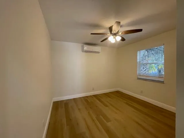 a view of room with a ceiling fan and a window