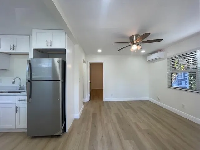 a view of a kitchen with closet and electronic appliances