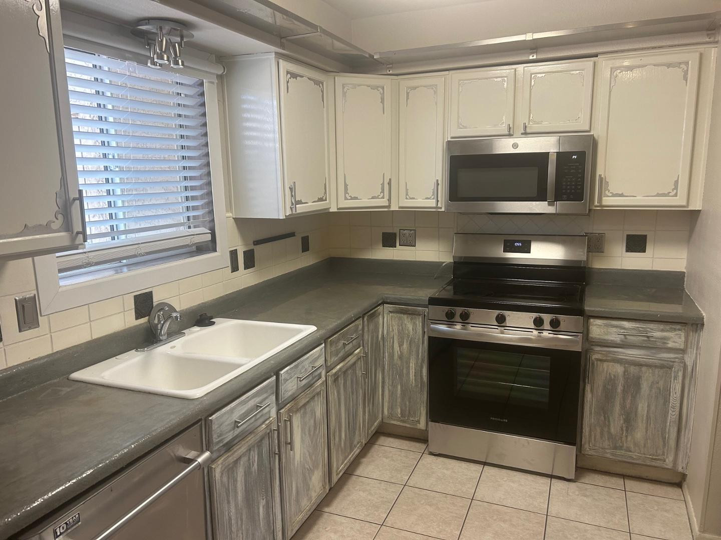 a kitchen with stainless steel appliances granite countertop a sink stove and microwave