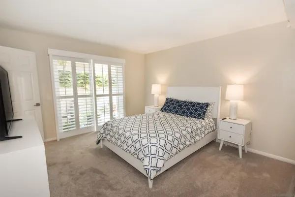 a bed sitting in a bedroom next to a window