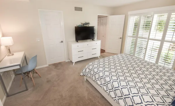 a bedroom with a bed and a flat screen tv