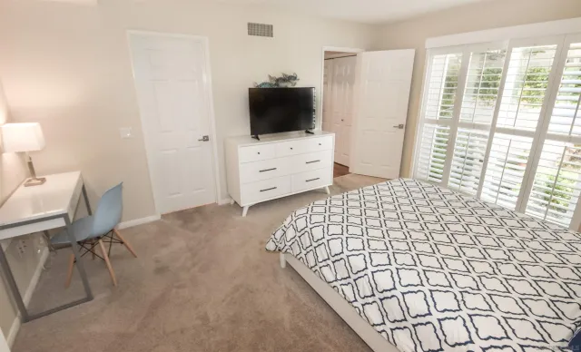 a bedroom with a bed and a flat screen tv