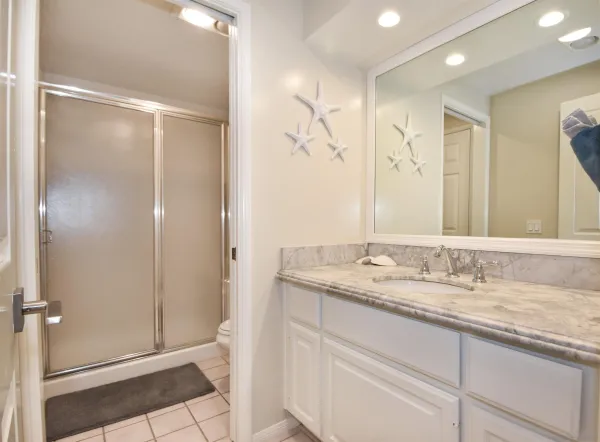 a bathroom with a granite countertop sink mirror and double