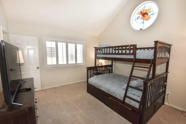 a bedroom with a bed and a chandelier