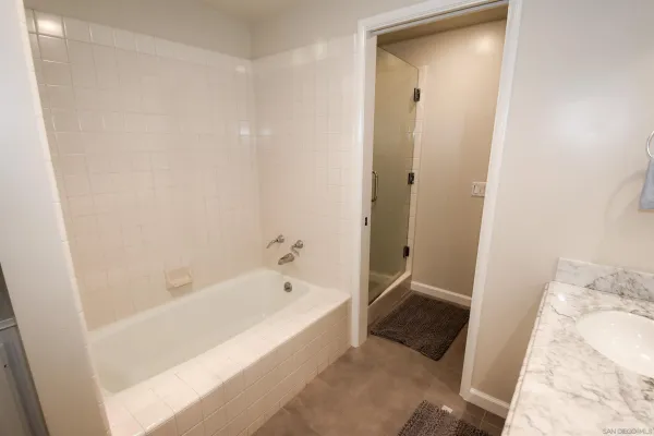 a bathroom with a bathtub and a shower