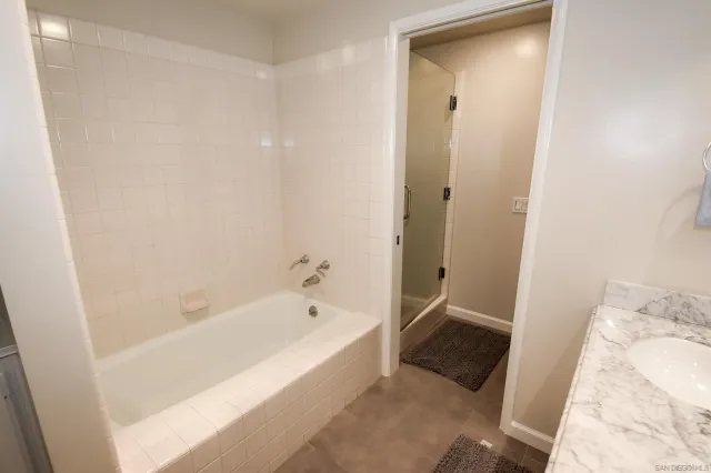 a bathroom with a bathtub and a shower