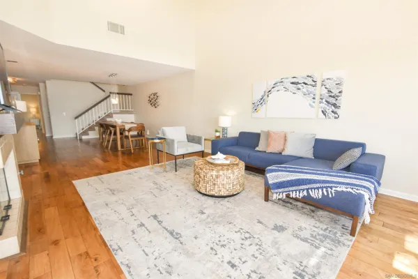 a living room with furniture and wooden floor