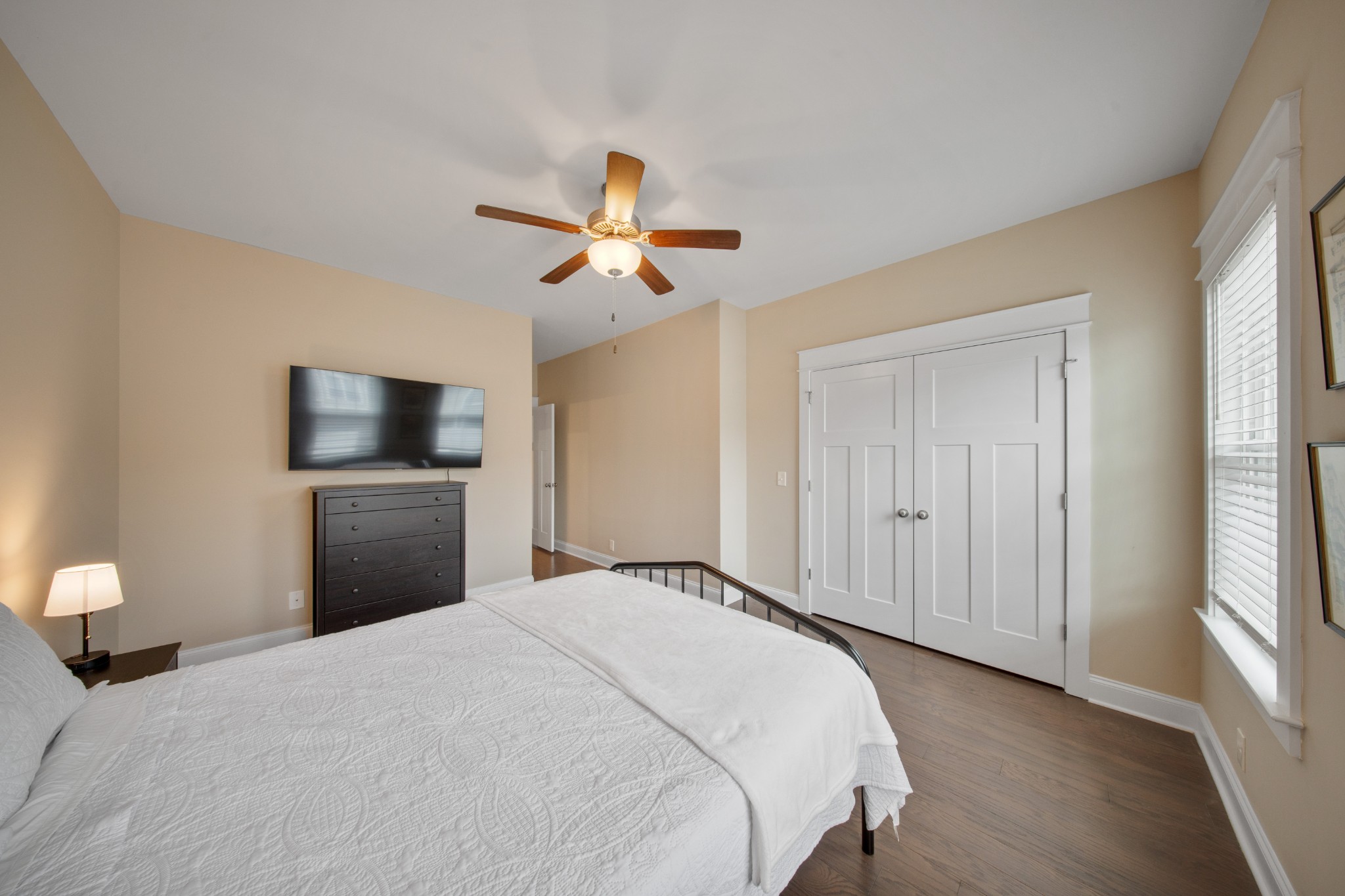 1019 North Maple Street, Unit 2B Murfreesboro, TN 37130 - Photo 22 of 26 a bedroom with a large bed and a chandelier