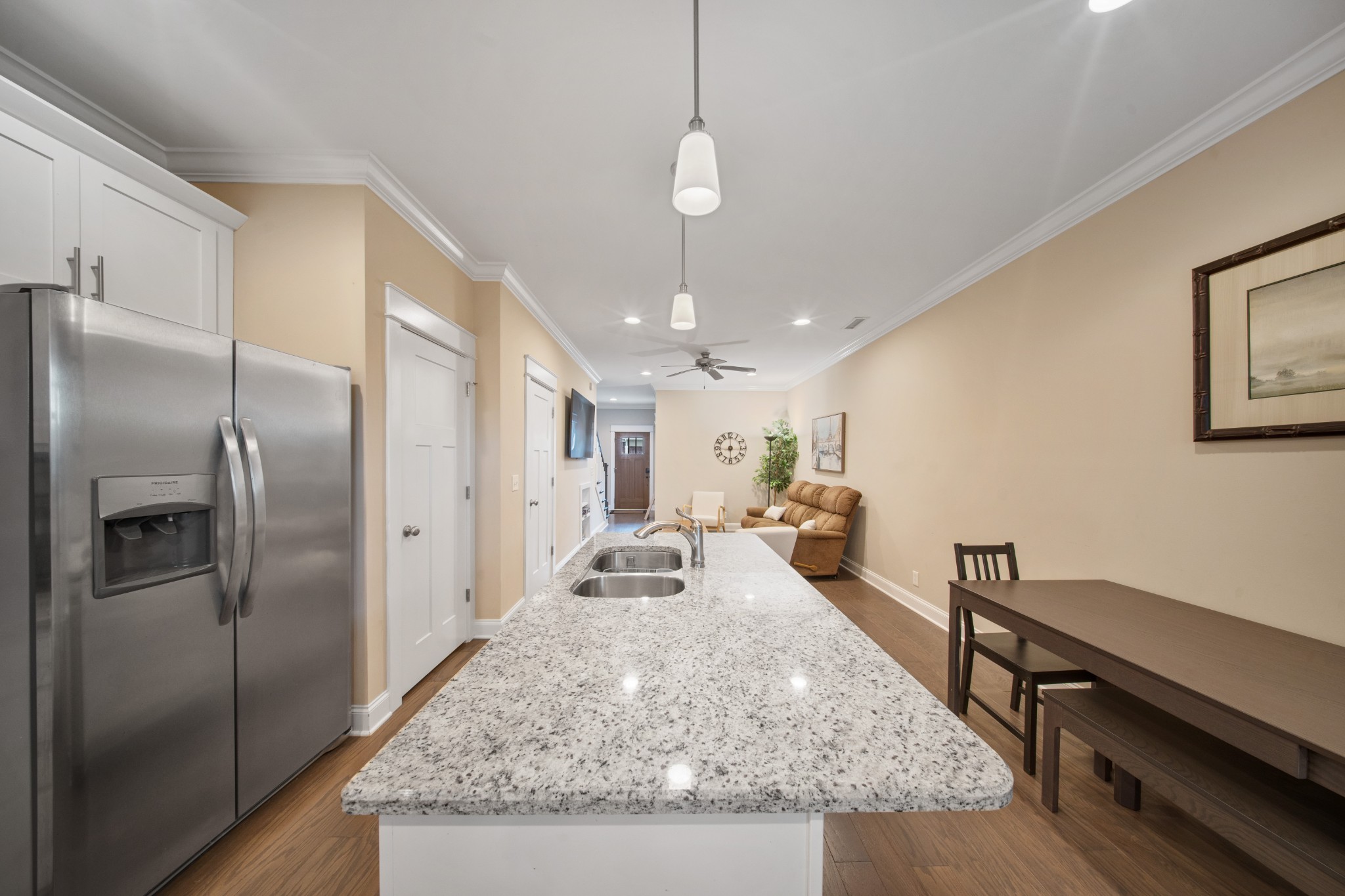 1019 North Maple Street, Unit 2B Murfreesboro, TN 37130 - Photo 5 of 26 a large kitchen with kitchen island a counter top space a sink stainless steel appliances and a chandelier