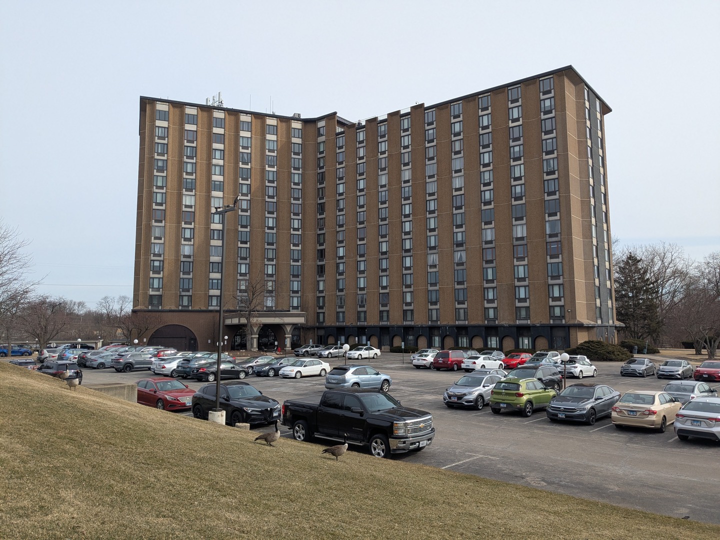 a couple of cars parked in front of a building