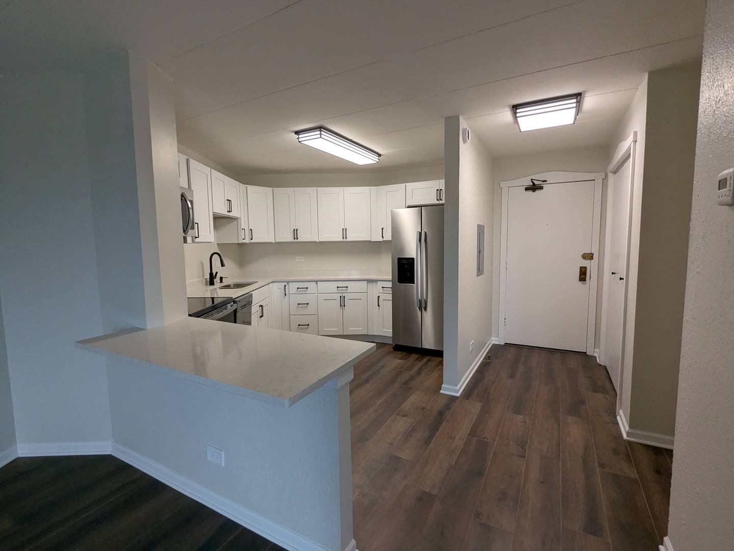 1 Renaissance Place, Unit 408 Palatine, IL 60067 - Photo 4 of 11 a kitchen with a sink a refrigerator and wooden floor