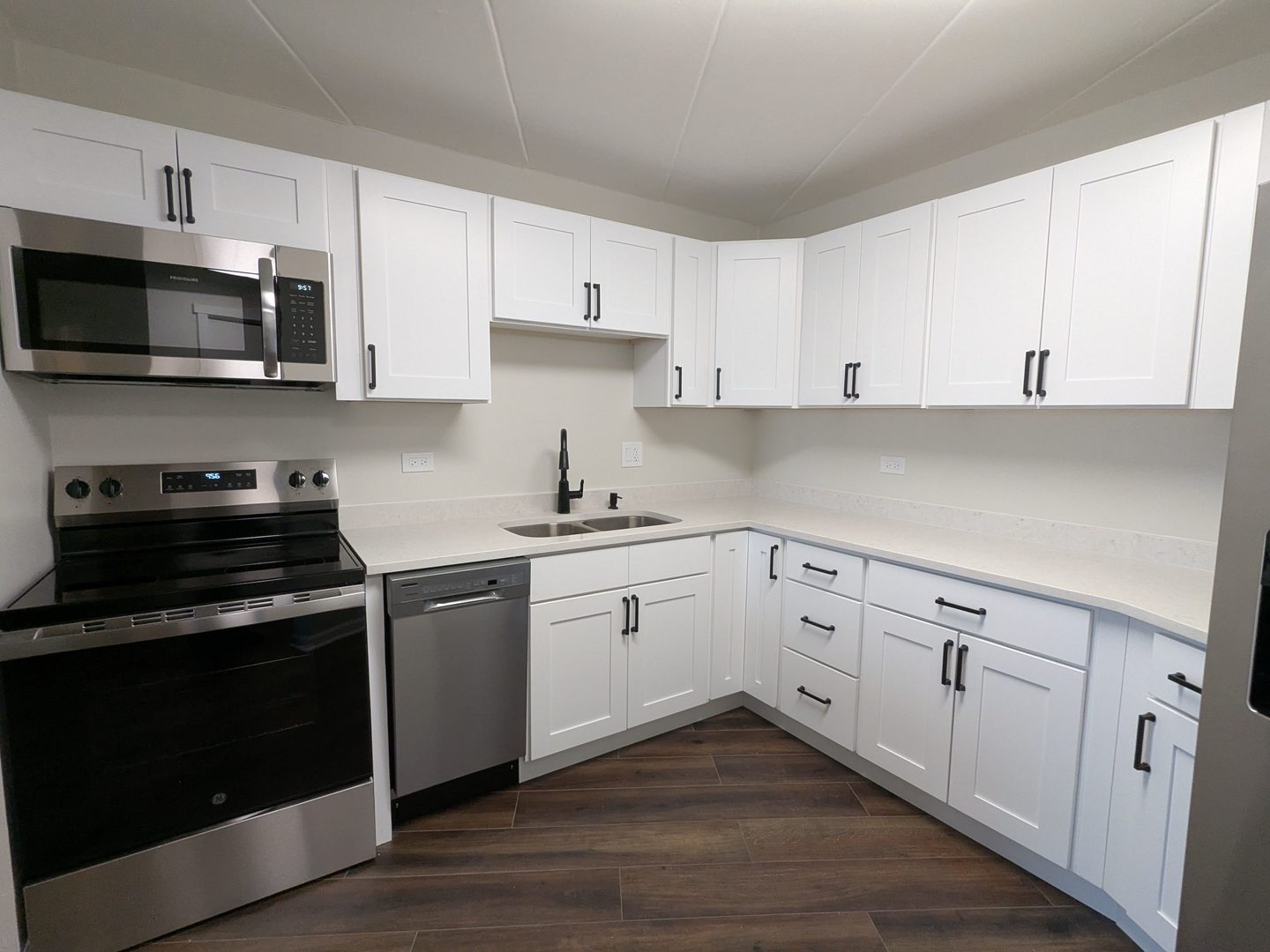 1 Renaissance Place, Unit 408 Palatine, IL 60067 - Photo 5 of 11 a kitchen with cabinets stainless steel appliances and wooden floor