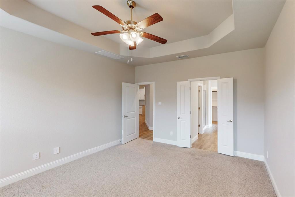 3017 Hampton Path Argyle, TX 76226 - Photo 14 of 37 an empty room with chandelier fan and windows
