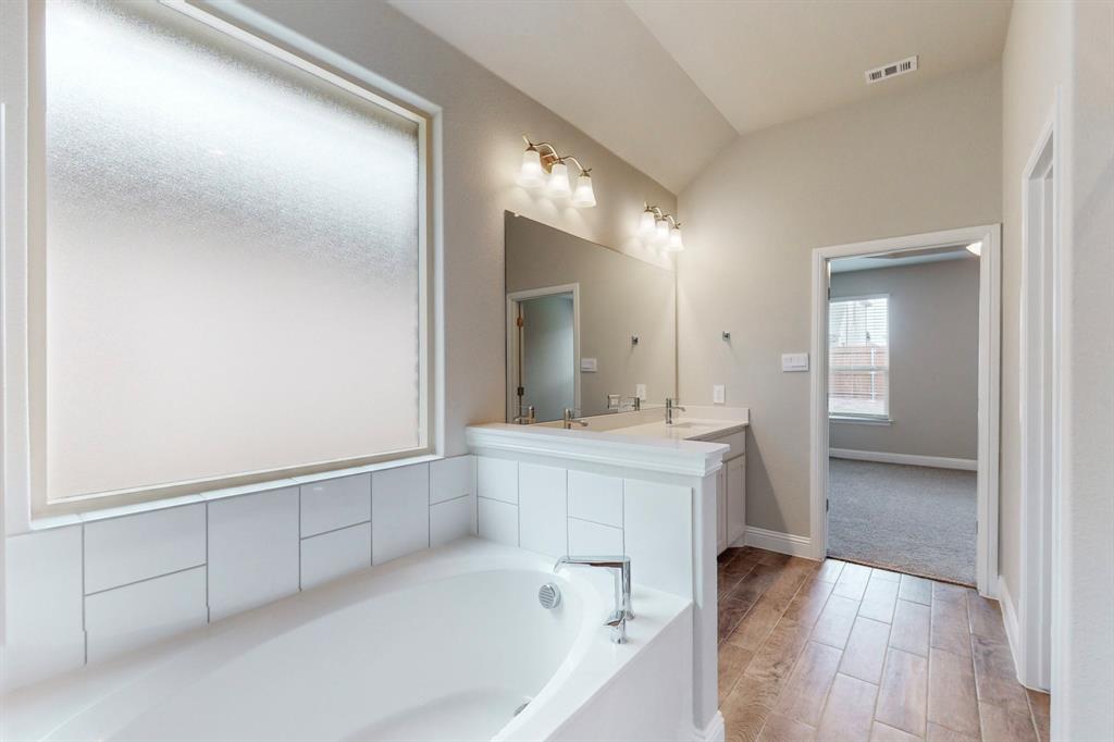 3017 Hampton Path Argyle, TX 76226 - Photo 18 of 37 a spacious bathroom with a bathtub sink and mirror