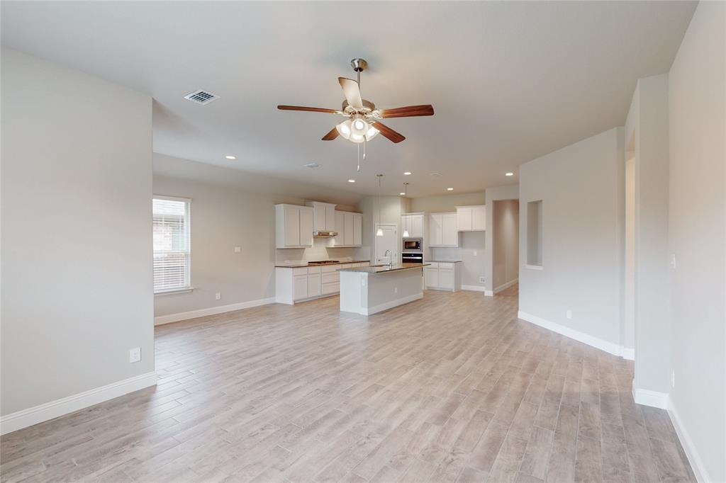 3017 Hampton Path Argyle, TX 76226 - Photo 32 of 37 a view of an empty room and kitchen view with wooden floor