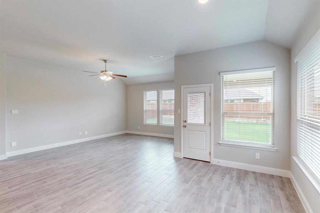 3017 Hampton Path Argyle, TX 76226 - Photo 6 of 37 an empty room with wooden floor and windows