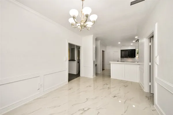 a view of a hallway with a kitchen