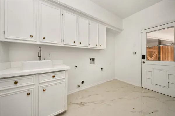 a kitchen with white cabinets and a sink