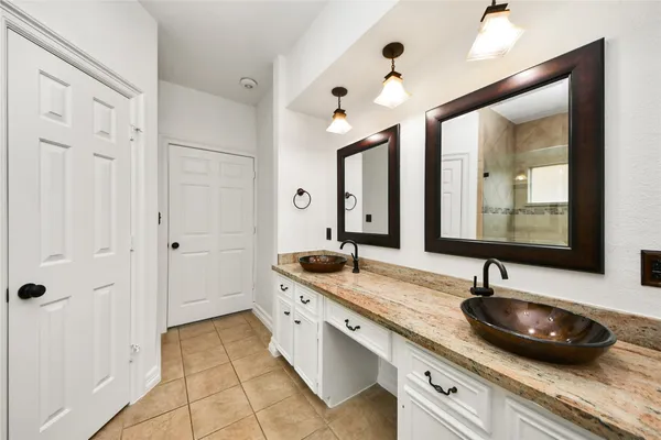 a bathroom with double sink and a mirror