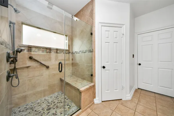 a bathroom with a glass shower door