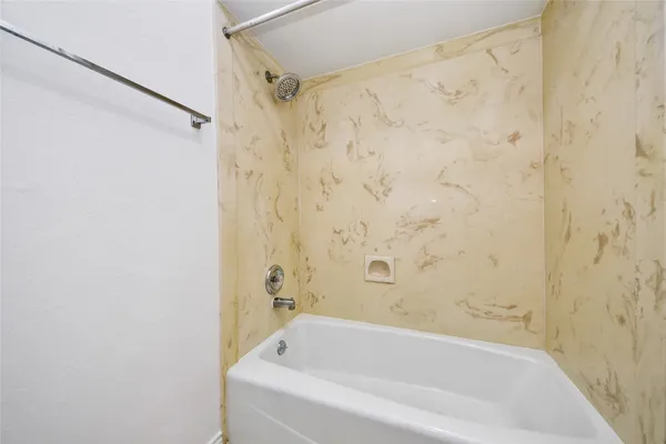 a bathroom with a bathtub and shower