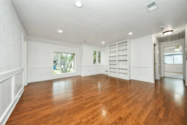 wooden floor in an empty room with a window