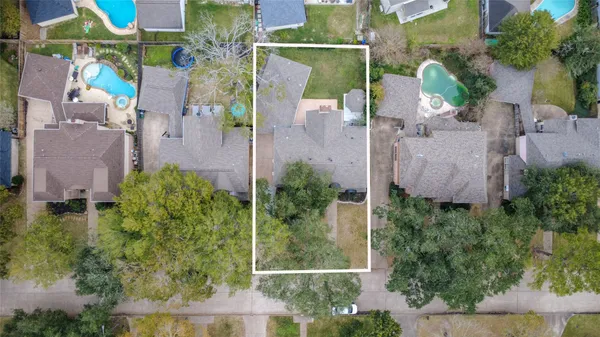 an aerial view of a house with outdoor space