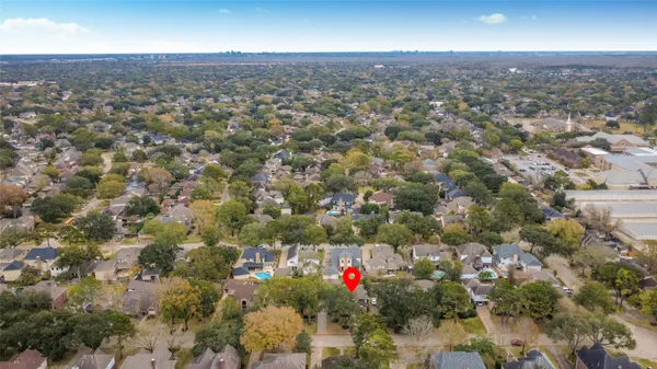 an aerial view of residential houses with city view and street view