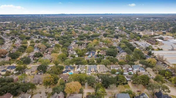 an aerial view of residential houses with city view