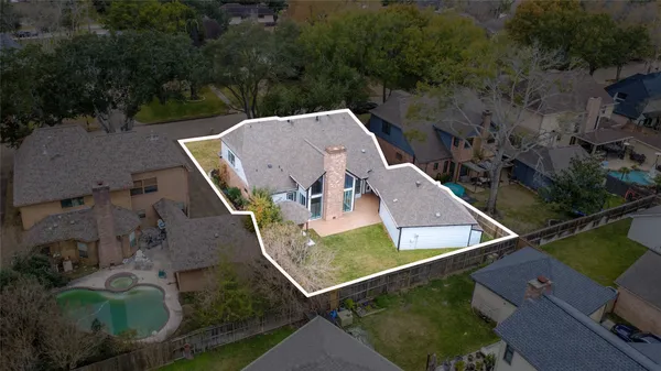 an aerial view of a house with a yard