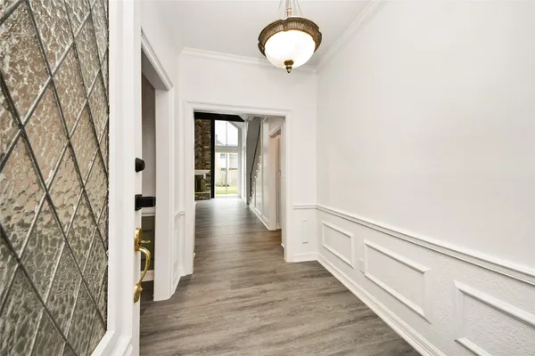 a view of a hallway with wooden floor