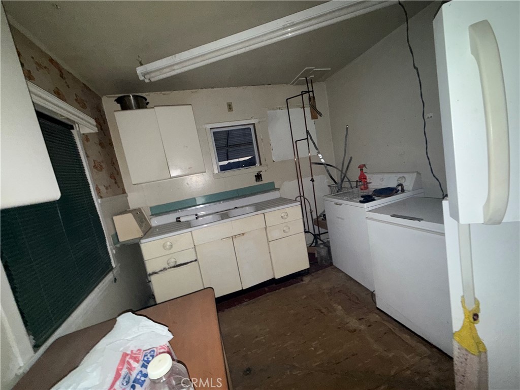 82480 3rd Street Trona, CA 93562 - Photo 11 of 15 a kitchen with a sink a microwave a washer and dryer