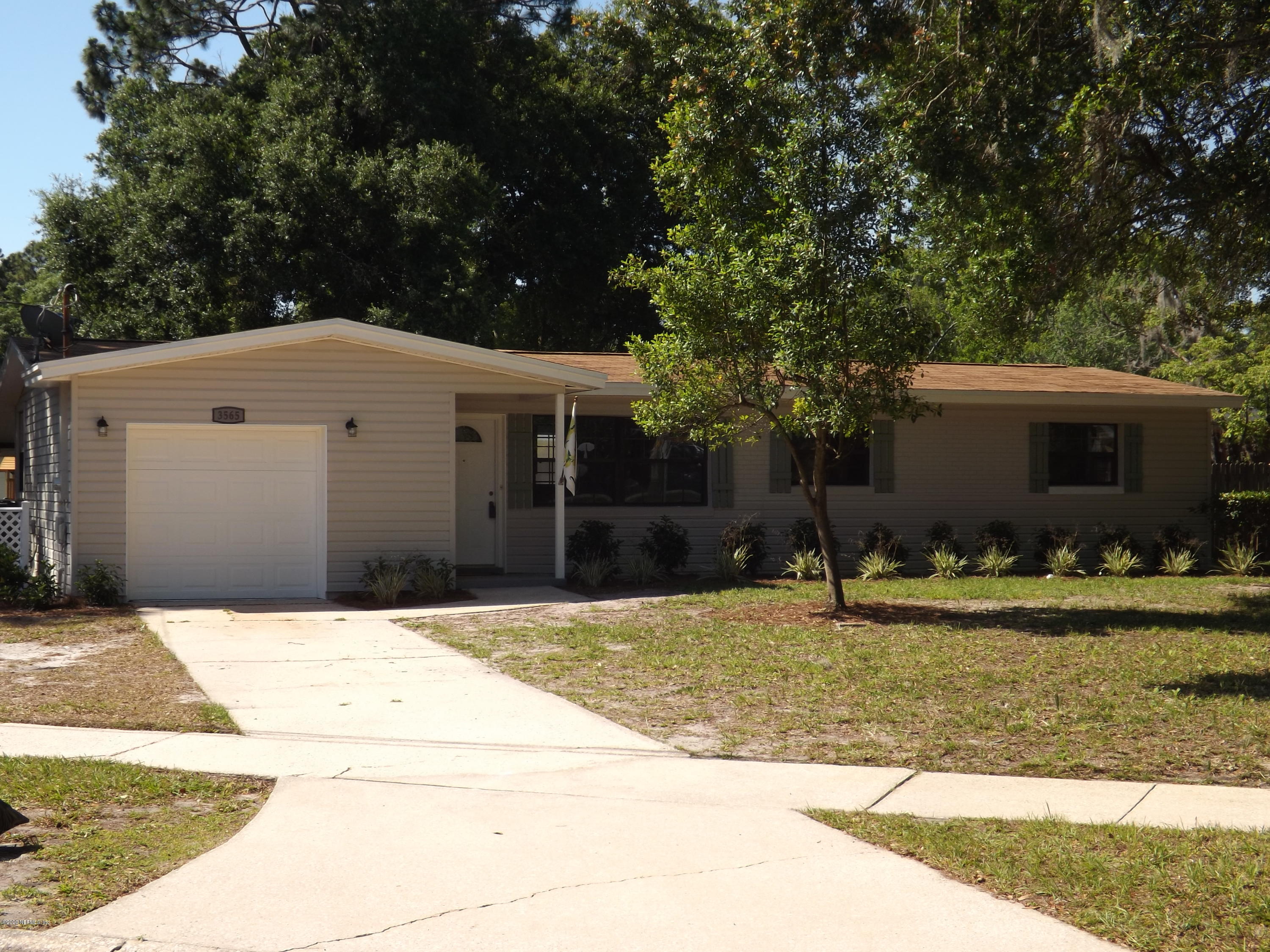 3565 Rogero Road Jacksonville, FL 32277 - Photo 1 of 74 a front view of a house with a yard