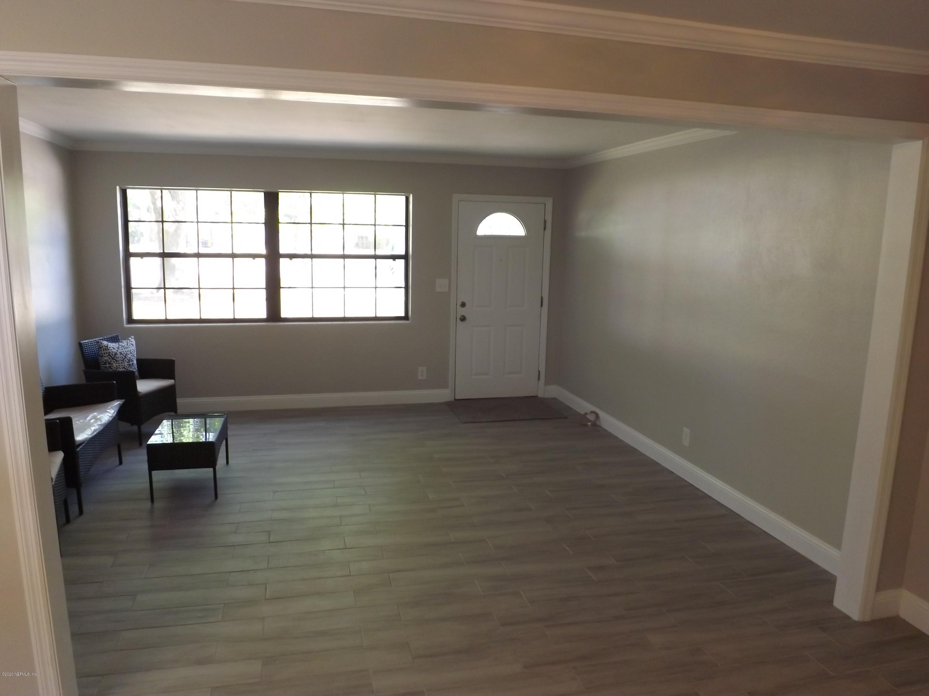 3565 Rogero Road Jacksonville, FL 32277 - Photo 14 of 74 a view of livingroom with furniture wooden floor and windows