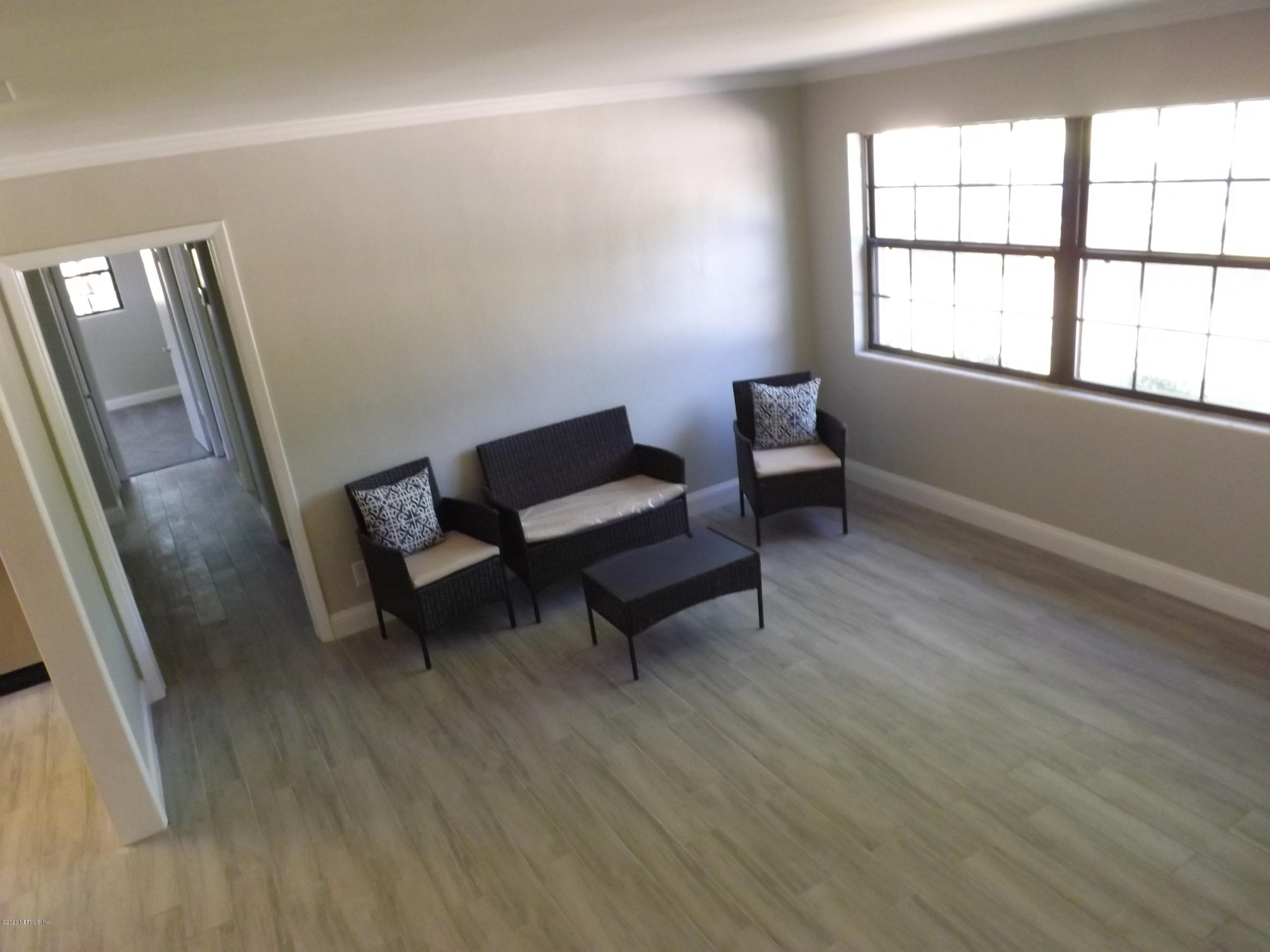 3565 Rogero Road Jacksonville, FL 32277 - Photo 16 of 74 a living room with furniture and a window