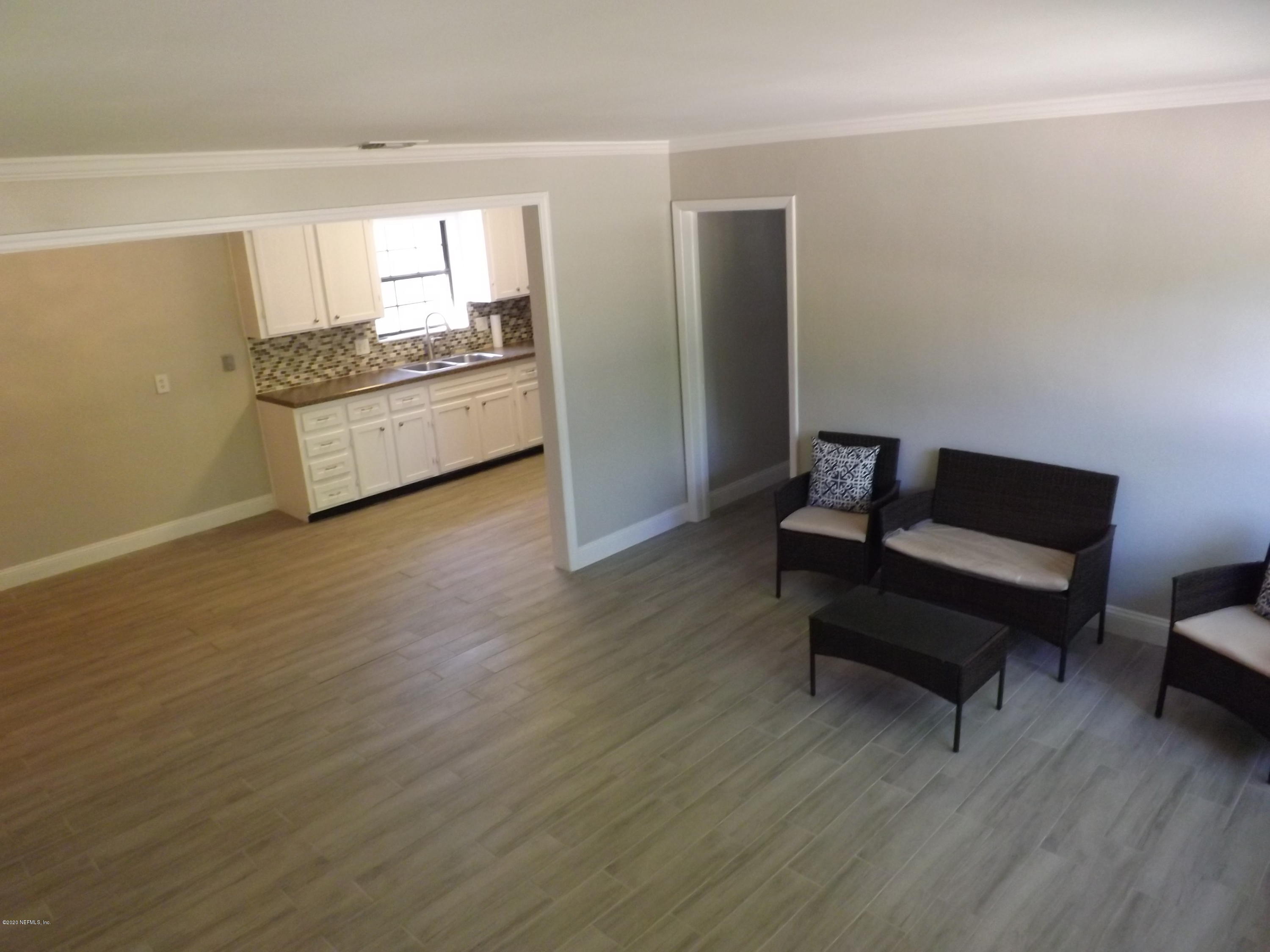 3565 Rogero Road Jacksonville, FL 32277 - Photo 17 of 74 a living room with furniture and a wooden floor