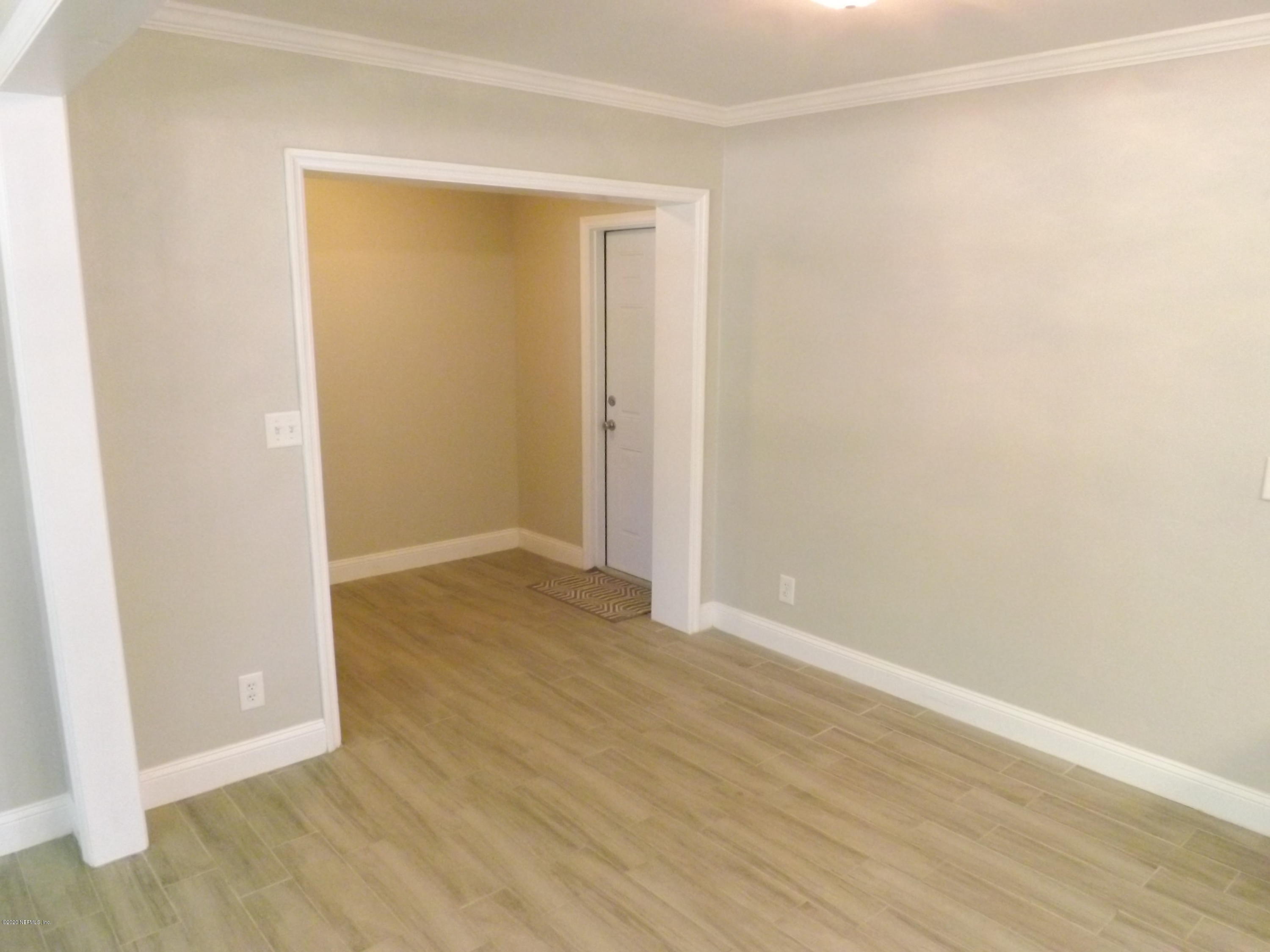 3565 Rogero Road Jacksonville, FL 32277 - Photo 19 of 74 a view of an empty room with wooden floor
